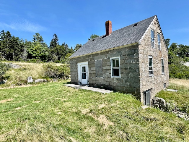 back of house with a yard