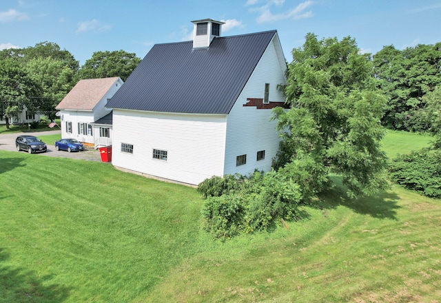 view of side of home with a yard