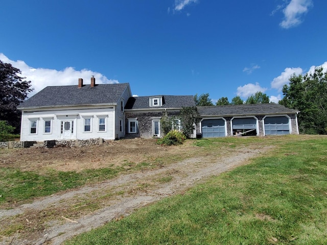 view of front of house with a front yard and a garage