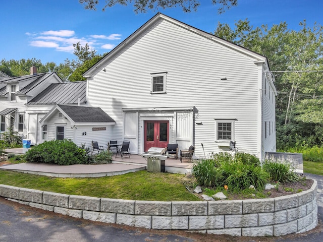 back of house featuring a patio, french doors, and a yard