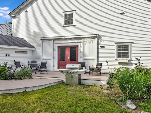 back of property with a patio area, french doors, and a yard