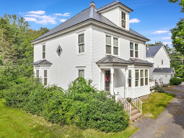 view of front of house featuring a sunroom