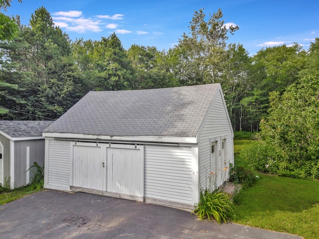 garage featuring a lawn