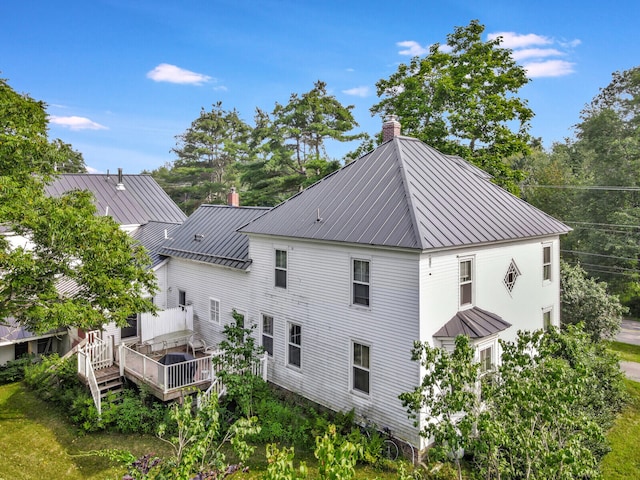 rear view of property with a wooden deck