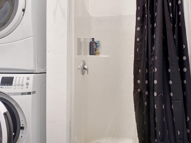 clothes washing area featuring stacked washer / drying machine