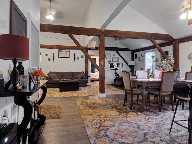 dining space featuring hardwood / wood-style flooring, ceiling fan, and vaulted ceiling