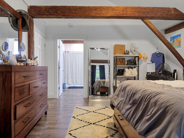 bedroom with beam ceiling, dark hardwood / wood-style flooring, and multiple windows