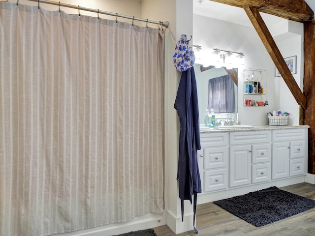 bathroom with shower / bath combination with curtain, vanity, and hardwood / wood-style flooring