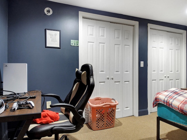 bedroom featuring two closets and carpet floors