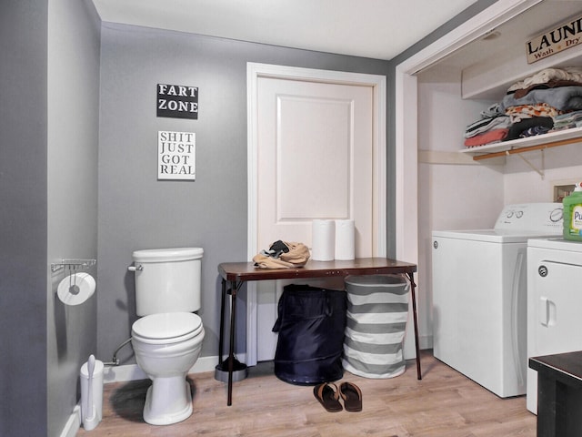 washroom featuring washing machine and dryer and light wood-type flooring