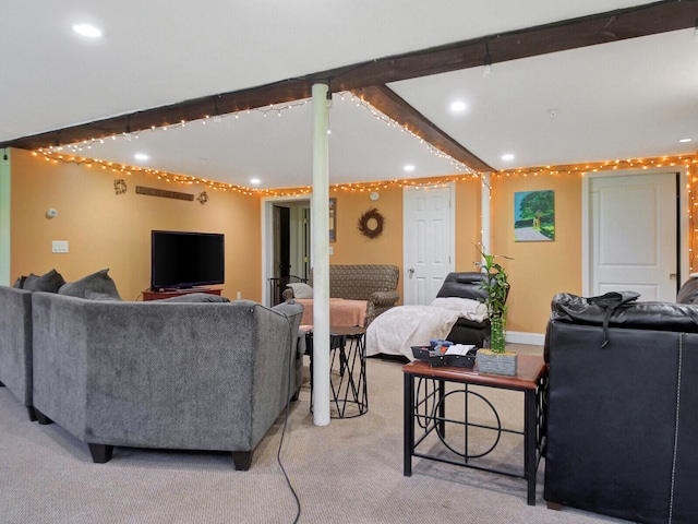 carpeted living room with beam ceiling