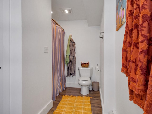 bathroom featuring toilet and hardwood / wood-style flooring