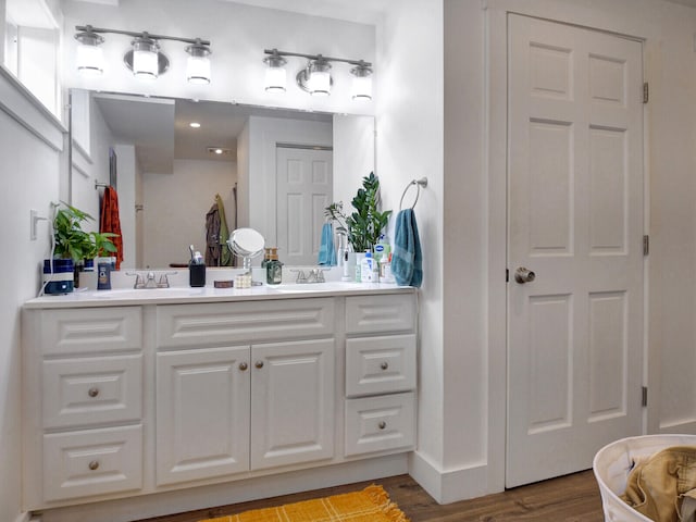 bathroom with vanity and wood-type flooring