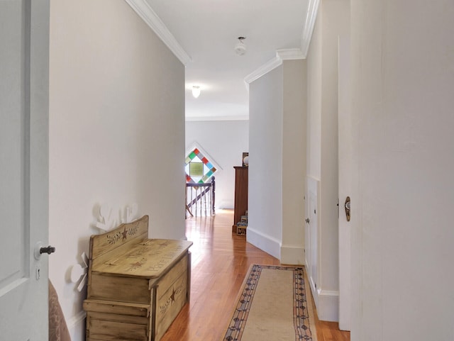 hallway with crown molding and light hardwood / wood-style flooring