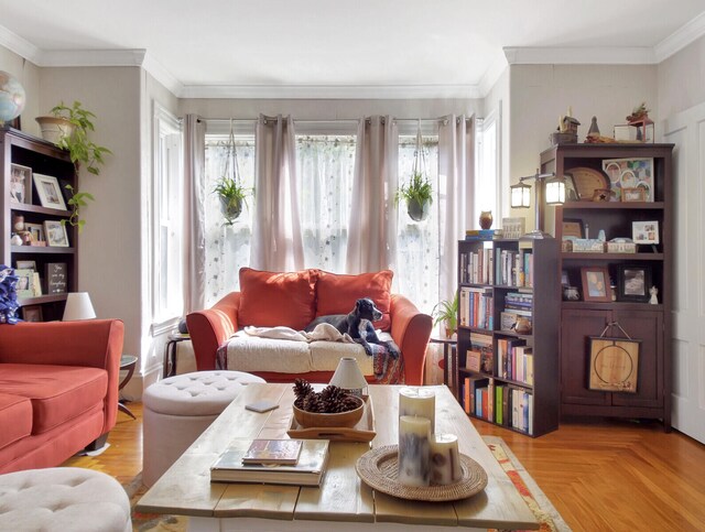 living room with ornamental molding and light parquet floors