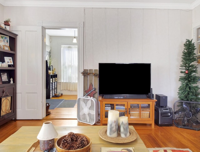 living room featuring crown molding and wood-type flooring