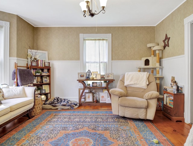 living area with a notable chandelier and hardwood / wood-style flooring