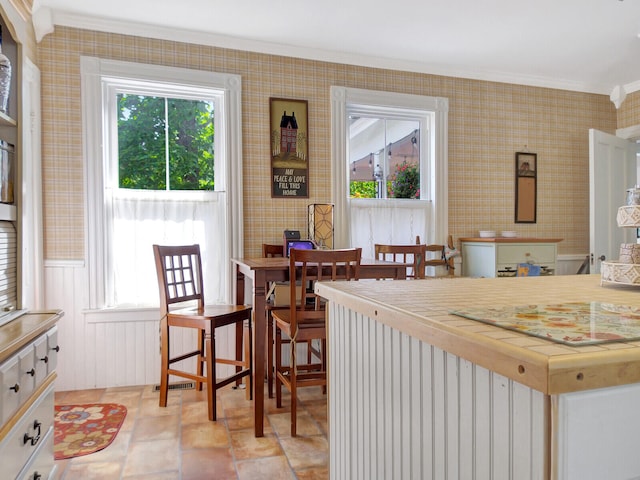 kitchen featuring ornamental molding and white cabinetry