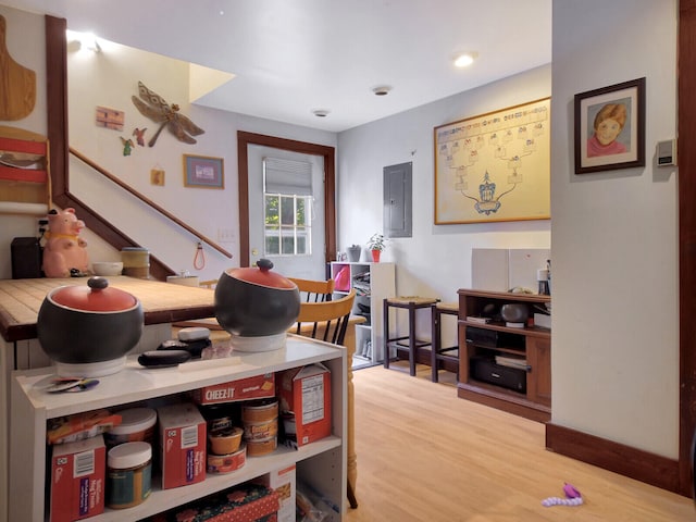 interior space with electric panel and light hardwood / wood-style flooring