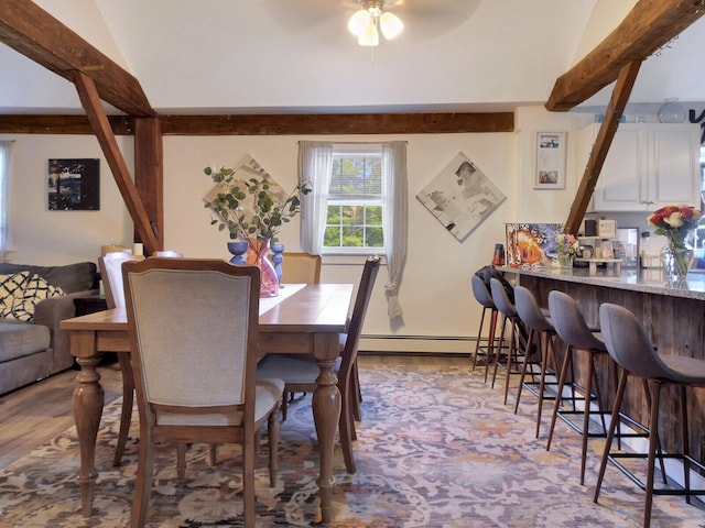 dining room with lofted ceiling, ceiling fan, and a baseboard radiator