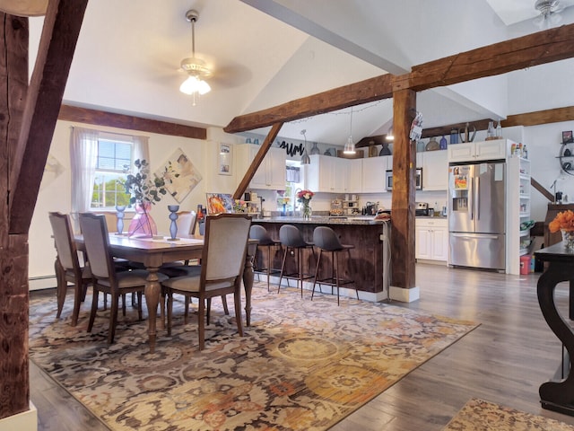 dining area featuring baseboard heating, ceiling fan, vaulted ceiling with beams, and dark hardwood / wood-style floors