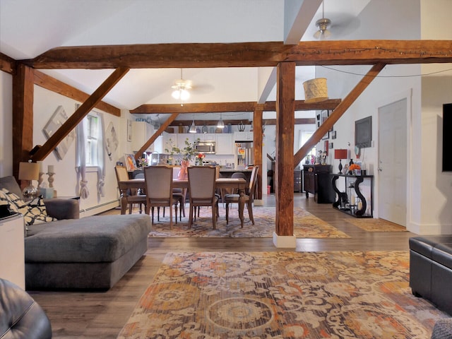 living room with baseboard heating, ceiling fan, lofted ceiling with beams, and wood-type flooring