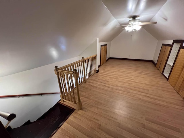 additional living space featuring vaulted ceiling, ceiling fan, and light hardwood / wood-style flooring