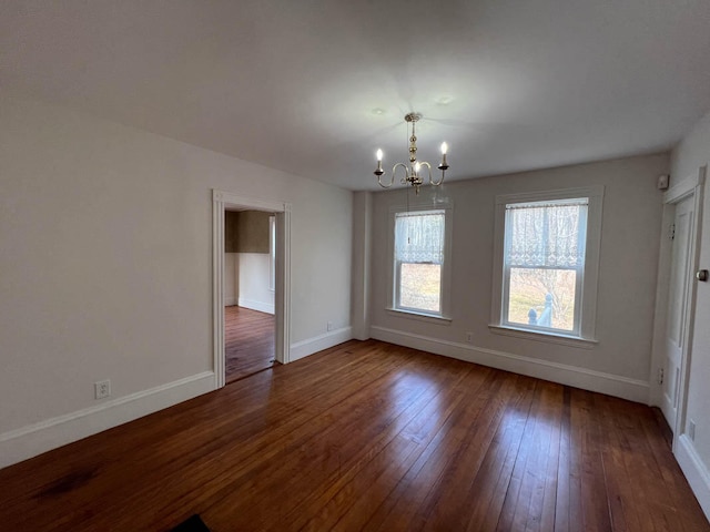 unfurnished dining area with a notable chandelier and dark hardwood / wood-style flooring