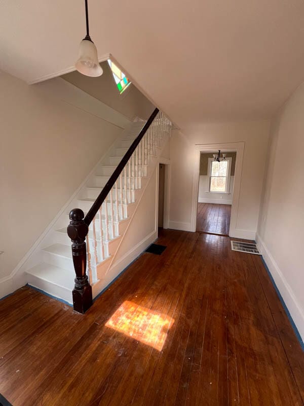 stairway featuring hardwood / wood-style flooring