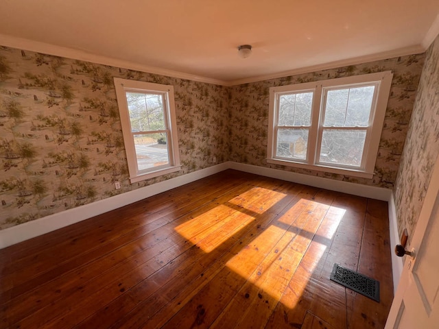 unfurnished room featuring hardwood / wood-style flooring and crown molding