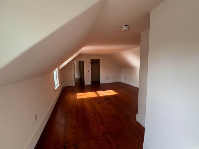 bonus room featuring vaulted ceiling and dark hardwood / wood-style floors