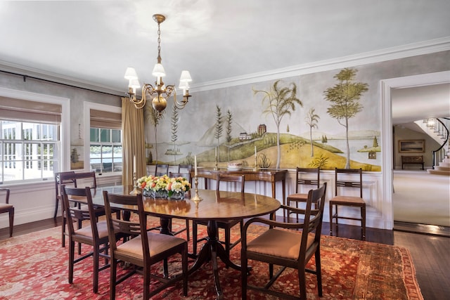 dining area with dark hardwood / wood-style flooring, a notable chandelier, and ornamental molding