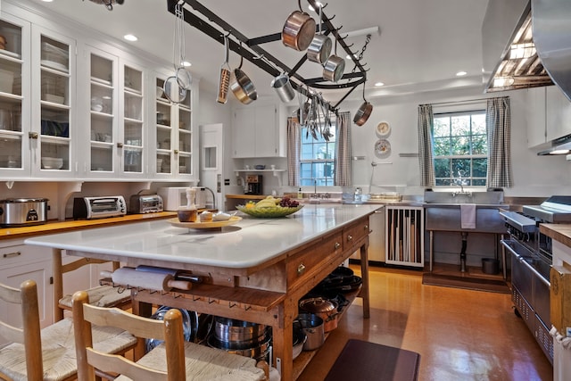 kitchen with a center island, white cabinetry, hanging light fixtures, and a chandelier