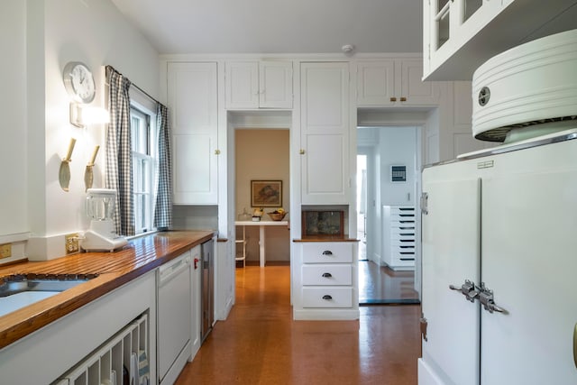 kitchen featuring white cabinets, refrigerator, dishwasher, and wooden counters