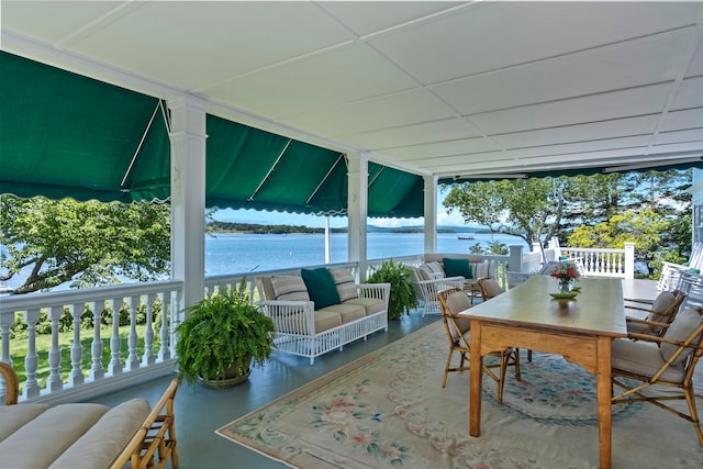 view of patio with a water view and an outdoor living space