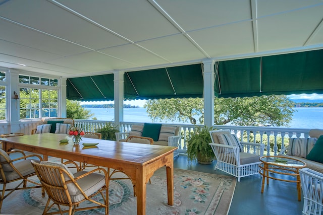 sunroom / solarium with a water view