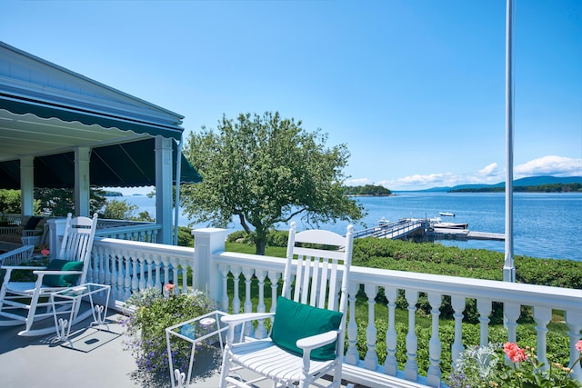 exterior space featuring a water view and a dock