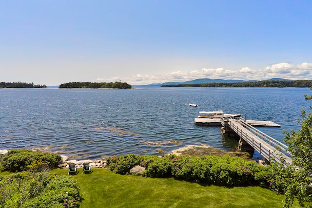 view of dock with a water and mountain view