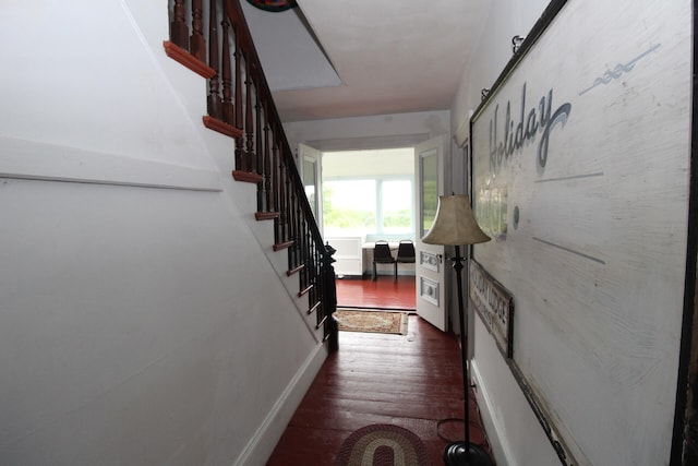 corridor with dark hardwood / wood-style flooring