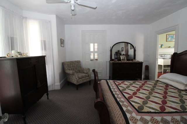 bedroom with ceiling fan, dark carpet, and multiple windows