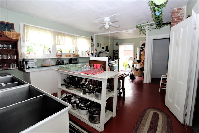 kitchen featuring white cabinets, ceiling fan, sink, and dark hardwood / wood-style flooring