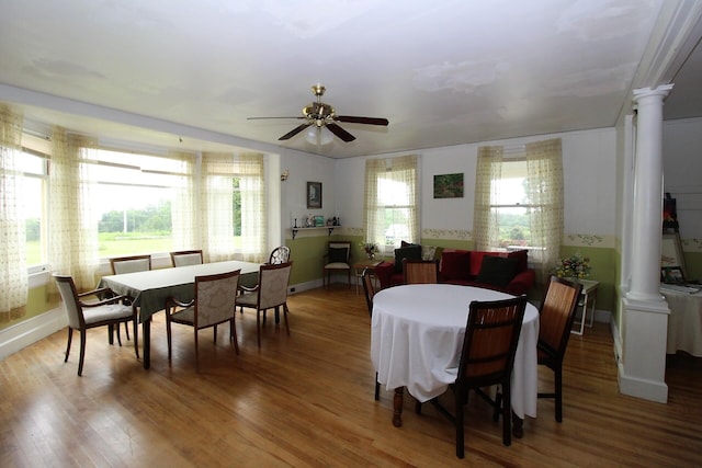 dining room featuring decorative columns, ceiling fan, and a healthy amount of sunlight