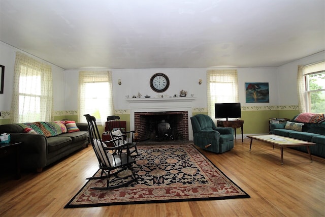 living room featuring light wood-type flooring and a fireplace