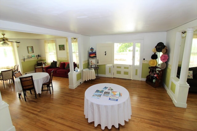 interior space with hardwood / wood-style floors, ceiling fan, and decorative columns