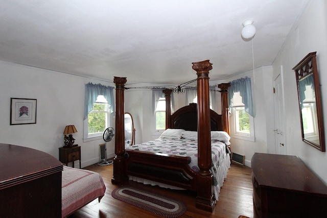 bedroom featuring ornamental molding and wood-type flooring