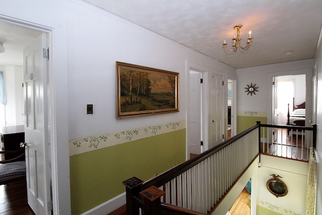 hallway featuring dark hardwood / wood-style flooring and a notable chandelier