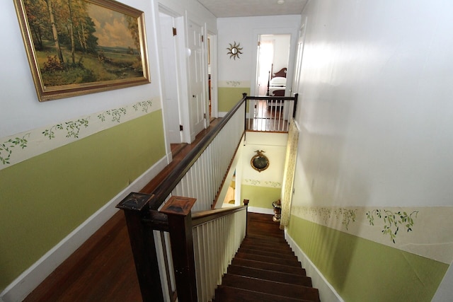 stairway with dark hardwood / wood-style floors