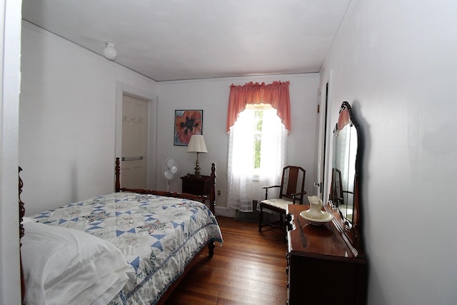 bedroom with dark wood-type flooring