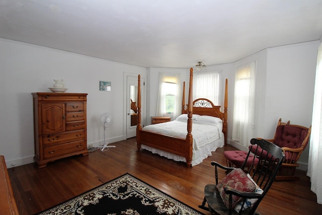 bedroom with dark hardwood / wood-style flooring