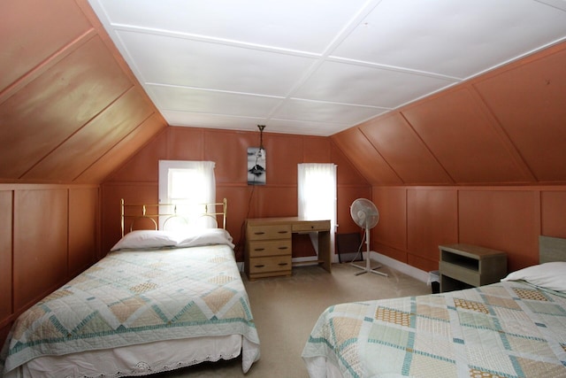 bedroom featuring lofted ceiling, light carpet, and wooden walls